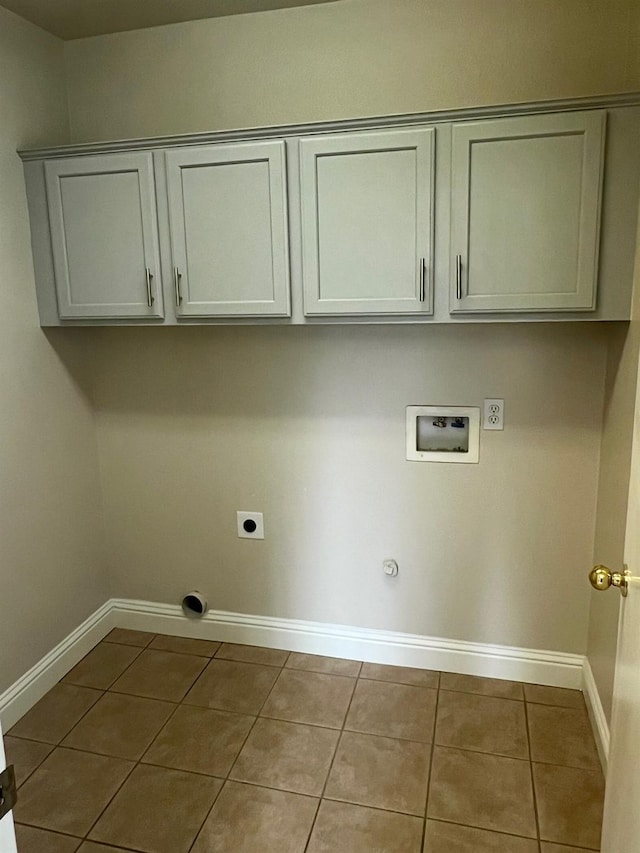 clothes washing area with light tile patterned floors, electric dryer hookup, hookup for a washing machine, cabinets, and hookup for a gas dryer