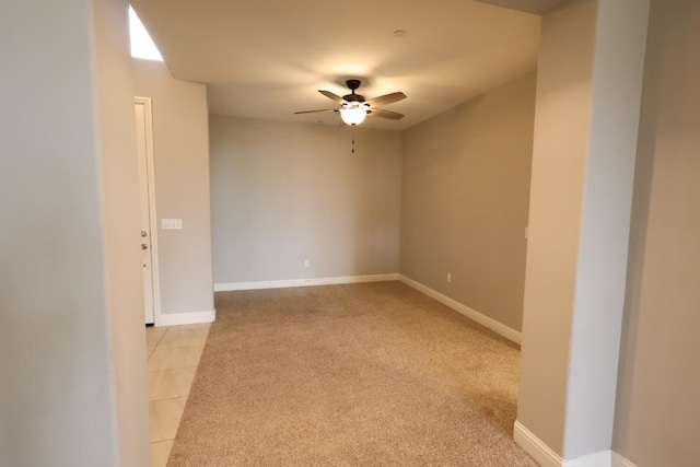 carpeted spare room with ceiling fan