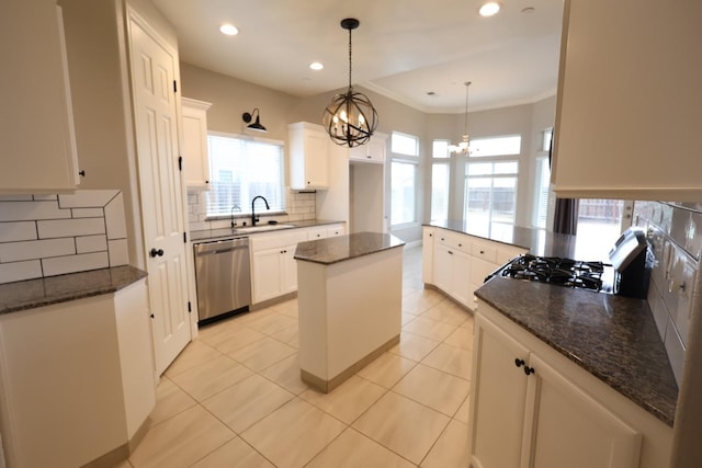 kitchen with dishwasher, stove, a center island, and white cabinets