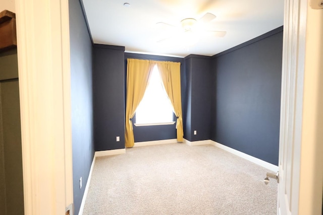 unfurnished room featuring ornamental molding, carpet, and ceiling fan