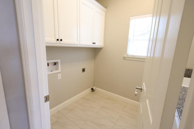 laundry area featuring electric dryer hookup, washer hookup, and cabinets