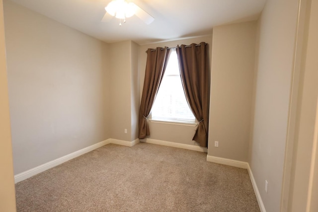 unfurnished room with light colored carpet and ceiling fan