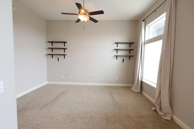 carpeted empty room featuring ceiling fan