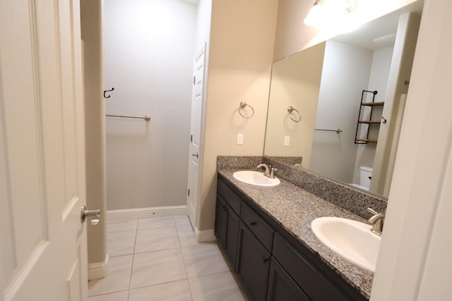 bathroom with vanity, tile patterned floors, and toilet