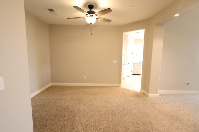 carpeted spare room featuring ceiling fan