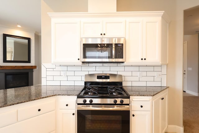 kitchen with tasteful backsplash, stainless steel appliances, and white cabinets