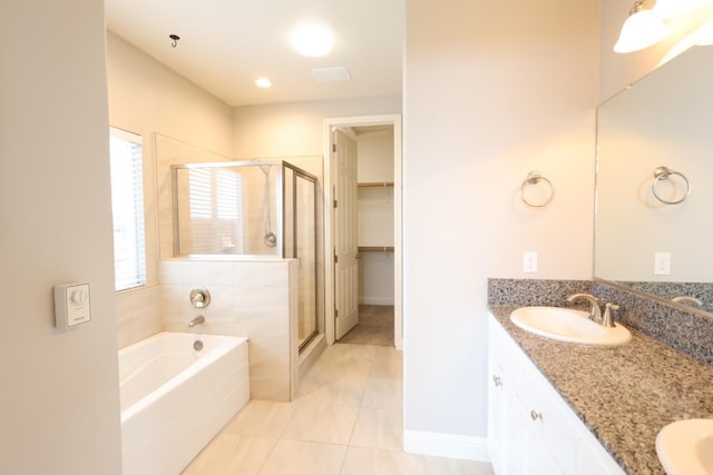 bathroom featuring tile patterned floors, vanity, and shower with separate bathtub