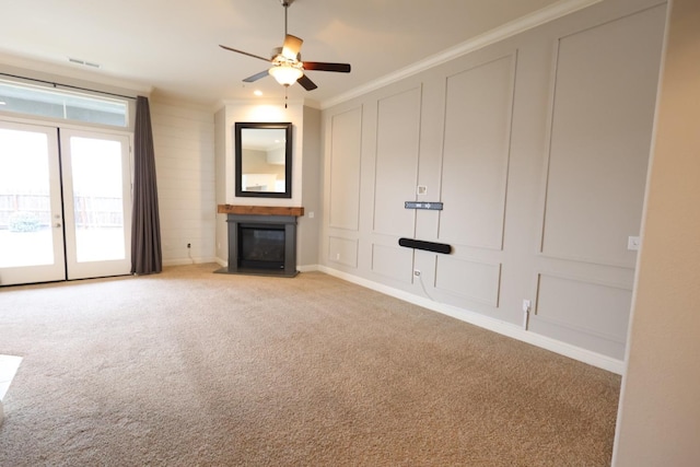 unfurnished living room with ornamental molding, light colored carpet, and ceiling fan