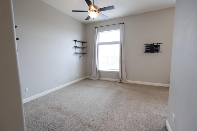 carpeted spare room featuring ceiling fan and lofted ceiling