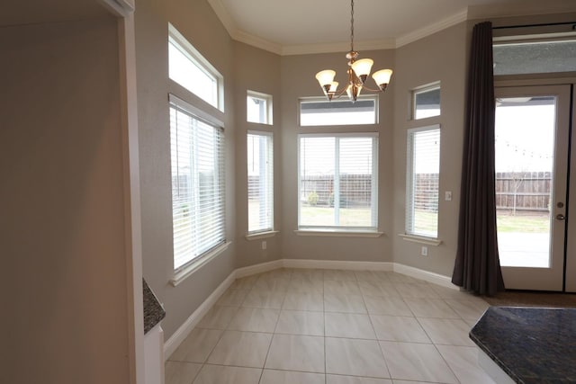 unfurnished dining area with crown molding, plenty of natural light, and a chandelier