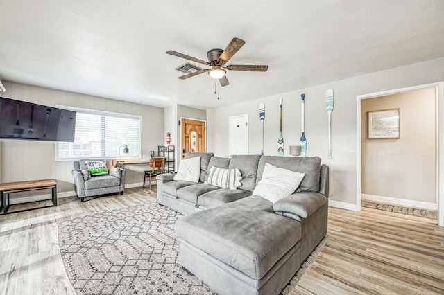 living room with ceiling fan and light hardwood / wood-style flooring