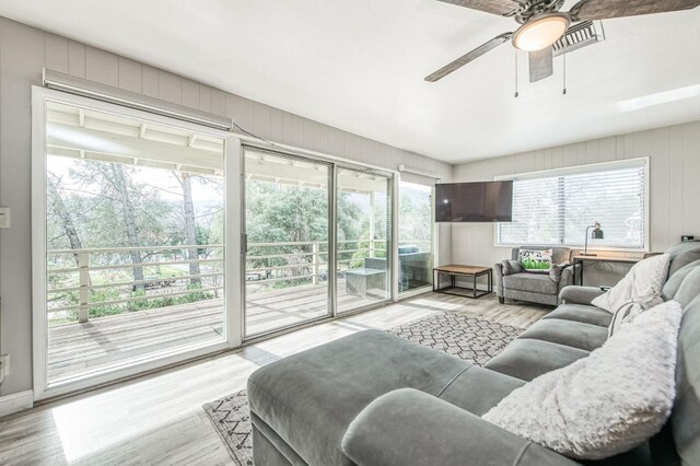 living room with ceiling fan and light hardwood / wood-style flooring