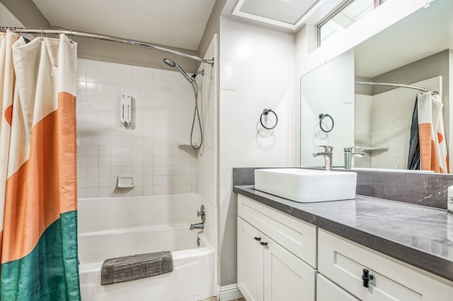 bathroom featuring shower / bathtub combination with curtain and vanity