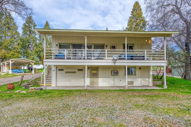 back of house with a yard and a carport