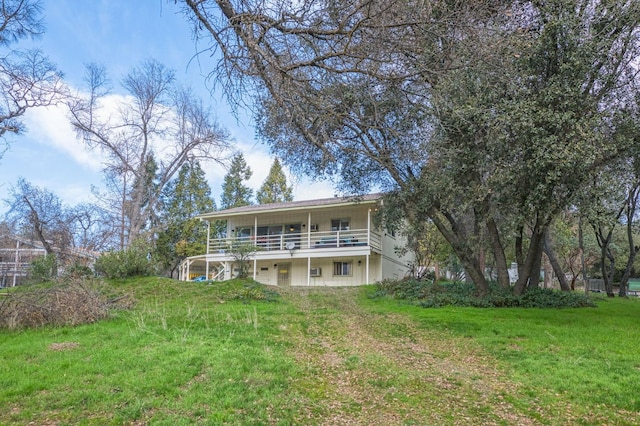 back of house with a lawn