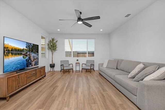 living room featuring light hardwood / wood-style floors and ceiling fan