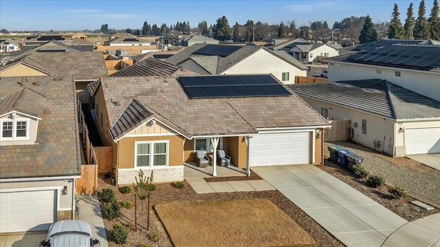 view of front facade with a garage and solar panels