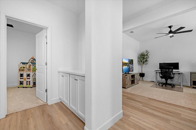 hall featuring beam ceiling and light hardwood / wood-style floors