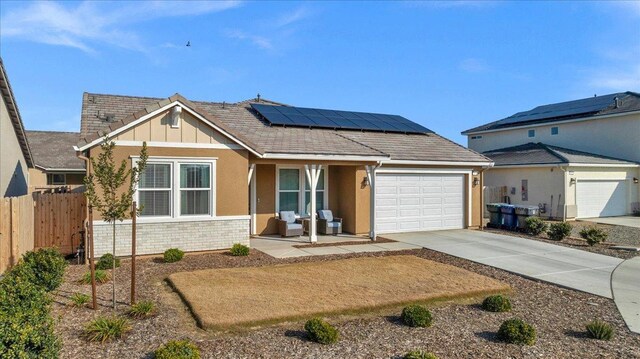 view of front of property with a garage and solar panels