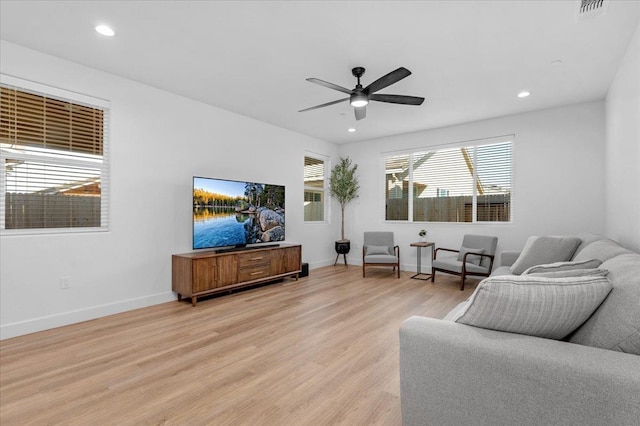 living room featuring ceiling fan and light hardwood / wood-style flooring