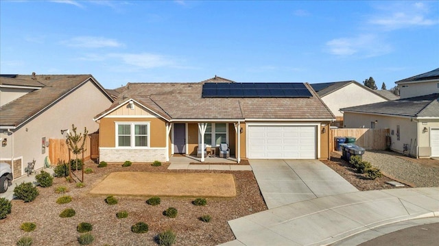 view of front of house with a garage and solar panels