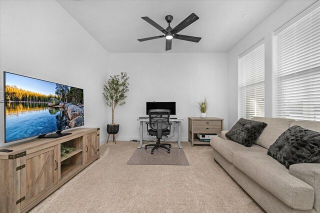 office with ceiling fan, light colored carpet, and plenty of natural light