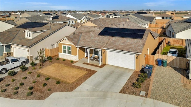 view of front facade with a garage and solar panels