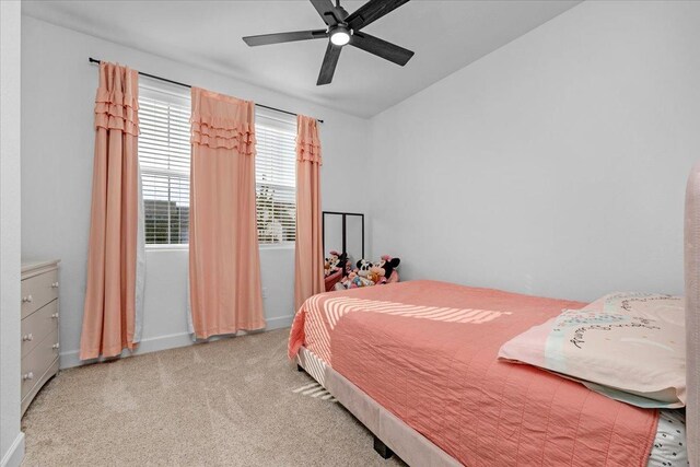 carpeted bedroom with lofted ceiling and ceiling fan