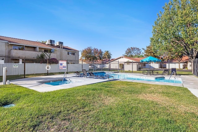 community pool featuring central AC and a patio area