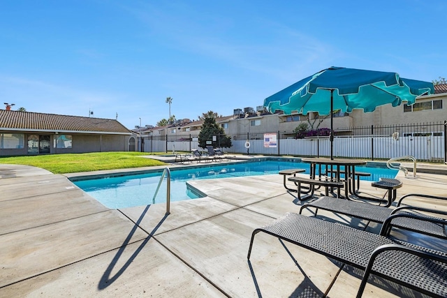 community pool with a patio and a residential view