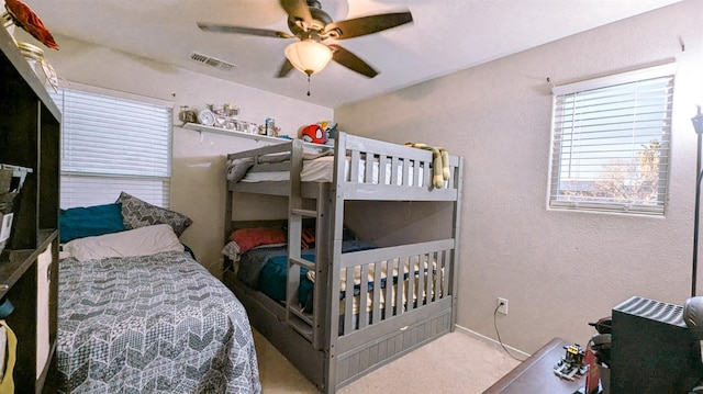 bedroom featuring light colored carpet and ceiling fan