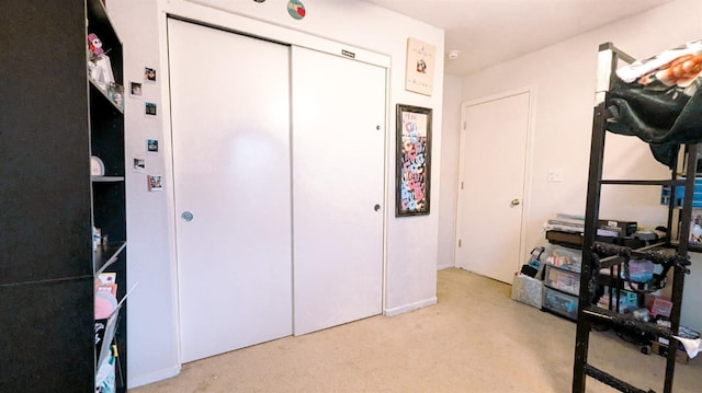 interior space featuring light colored carpet and a closet