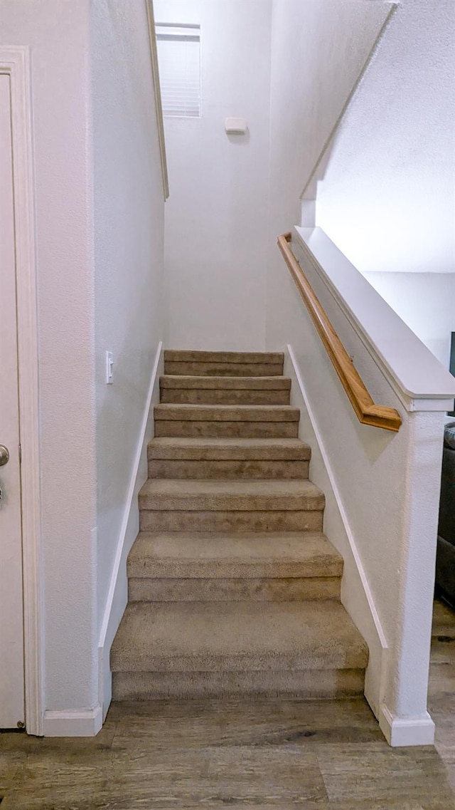 stairs featuring wood-type flooring