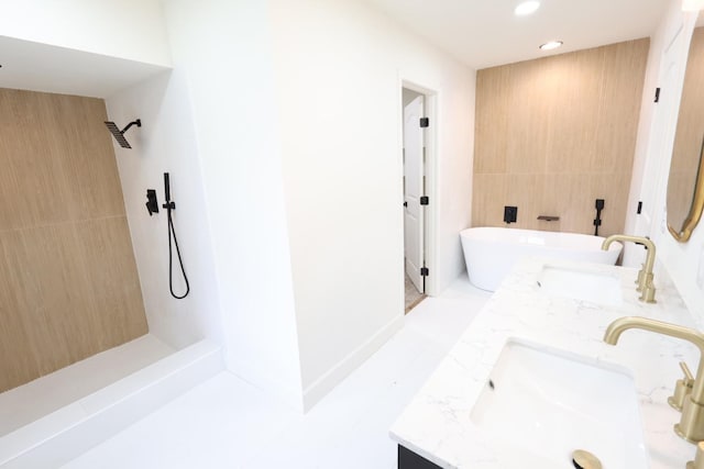 bathroom with vanity, plus walk in shower, and tile walls