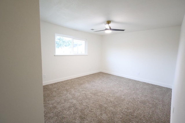 empty room featuring ceiling fan and carpet flooring