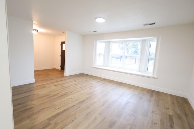 spare room with light hardwood / wood-style flooring