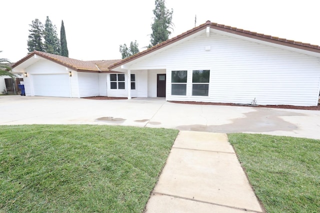 view of front of property with a garage and a front yard