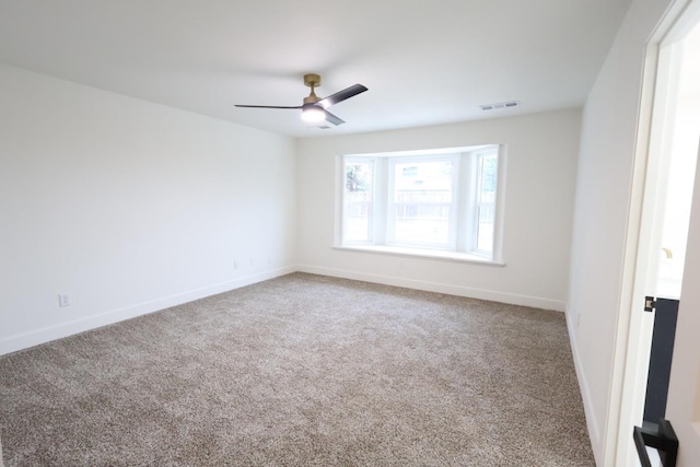 unfurnished room with ceiling fan and carpet flooring