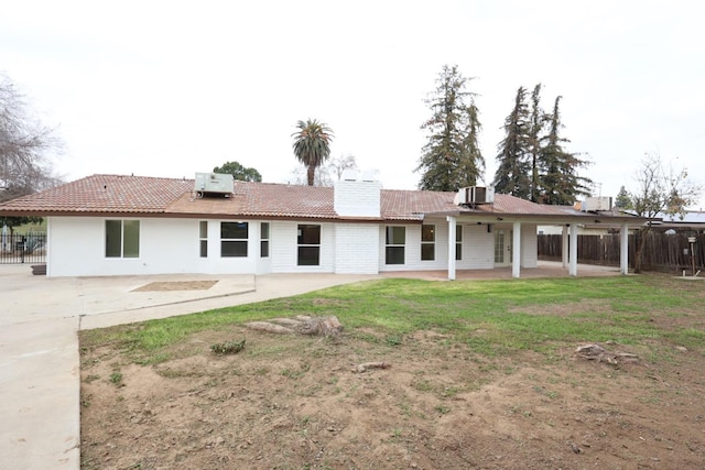 back of house with a lawn, central AC, and a patio area