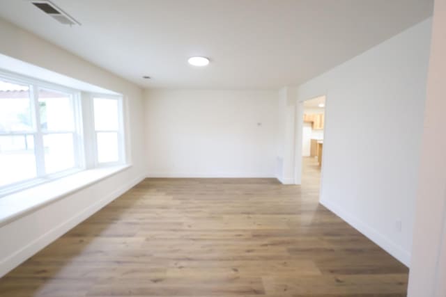 unfurnished room with light hardwood / wood-style flooring