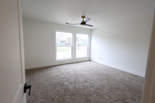 spare room featuring carpet floors and ceiling fan