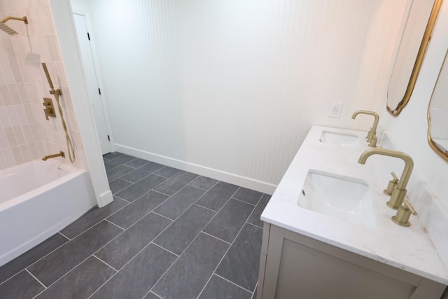 bathroom with tiled shower / bath and vanity