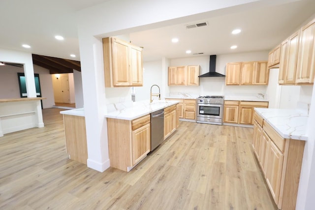 kitchen with sink, stainless steel appliances, light hardwood / wood-style floors, wall chimney exhaust hood, and light brown cabinets