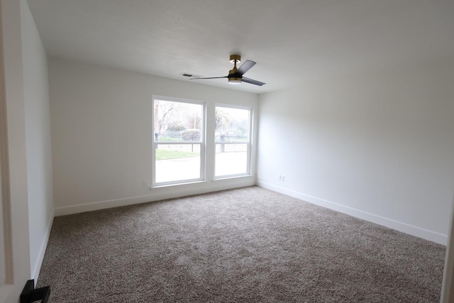 carpeted empty room featuring ceiling fan