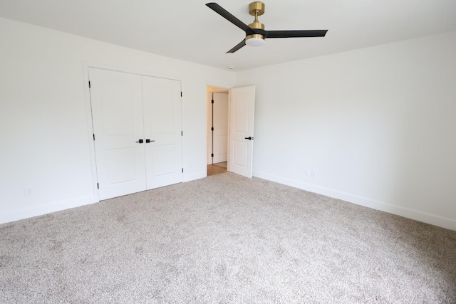 unfurnished bedroom with ceiling fan, carpet flooring, and a closet