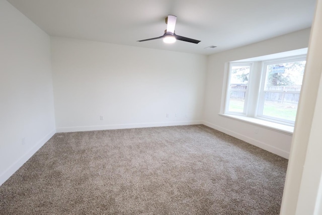 spare room with carpet floors and ceiling fan