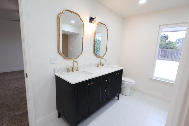 bathroom featuring a healthy amount of sunlight, toilet, and vanity