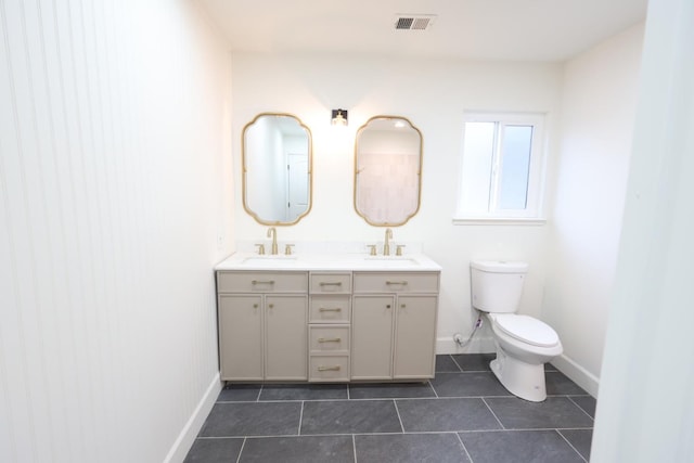 bathroom featuring vanity, tile patterned floors, and toilet