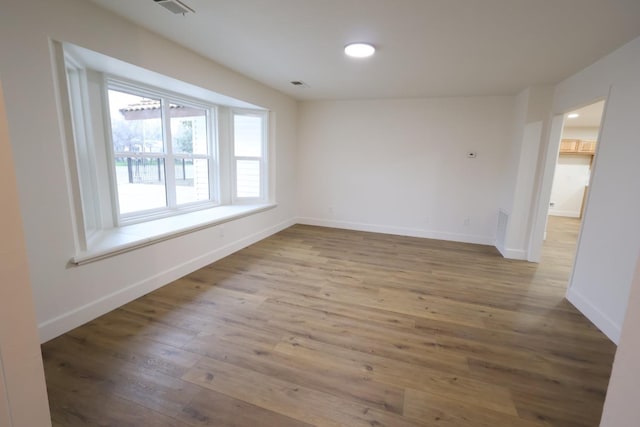 unfurnished room featuring hardwood / wood-style floors