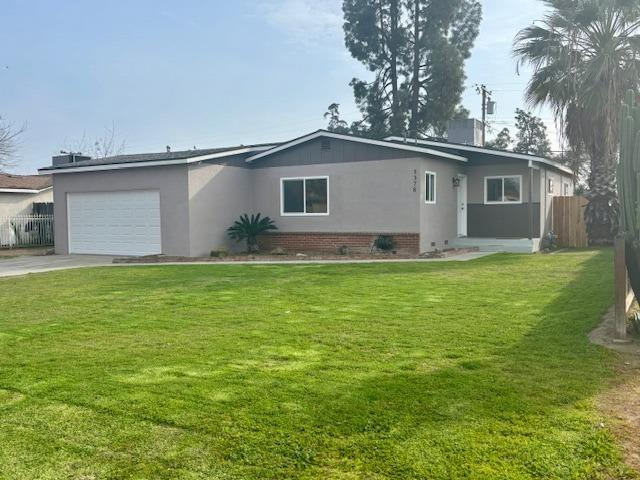 view of front facade featuring concrete driveway, an attached garage, crawl space, fence, and a front lawn